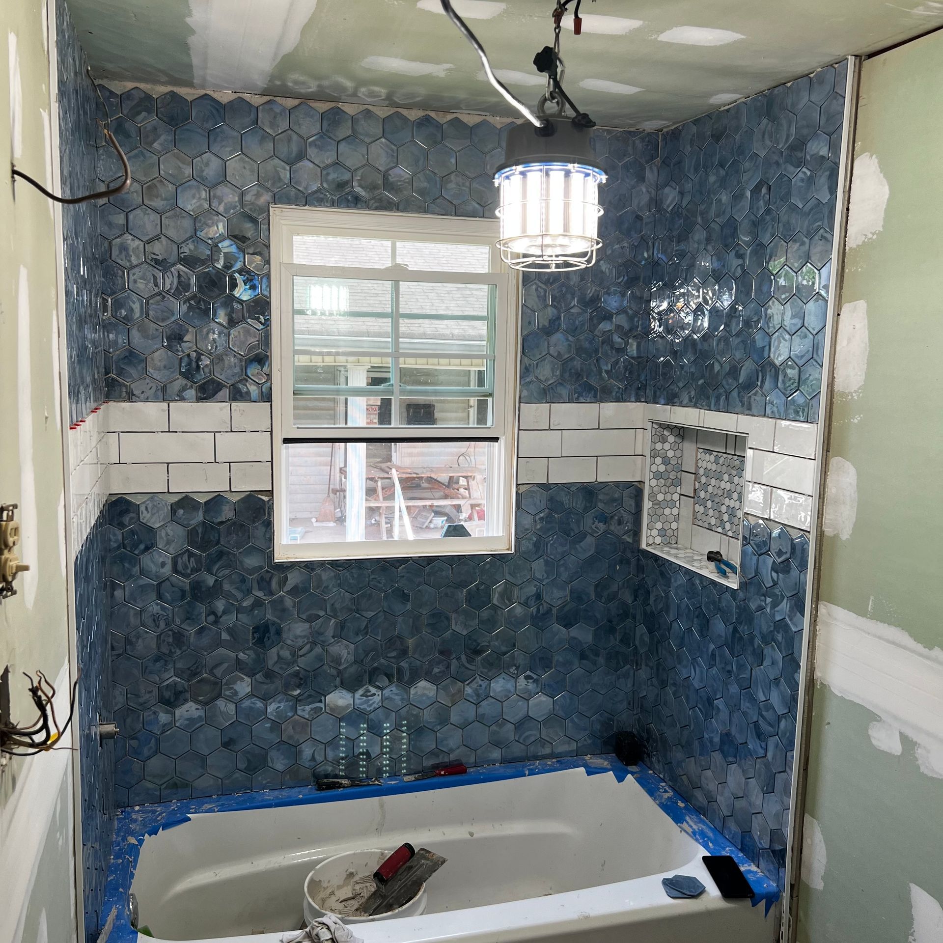 White kitchen cabinets installed in a new construction kitchen.