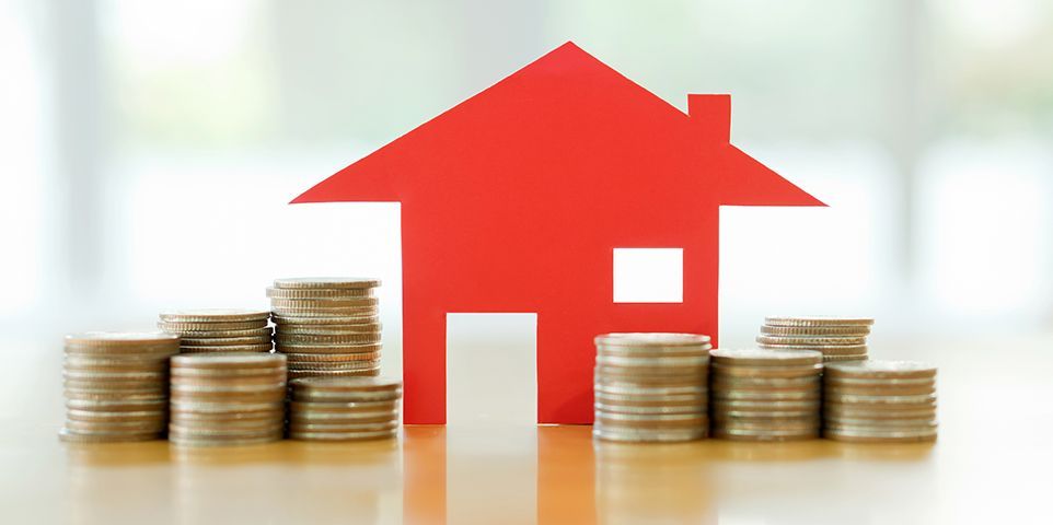 Red home icon with coins representing rising ND home insurance premiums.