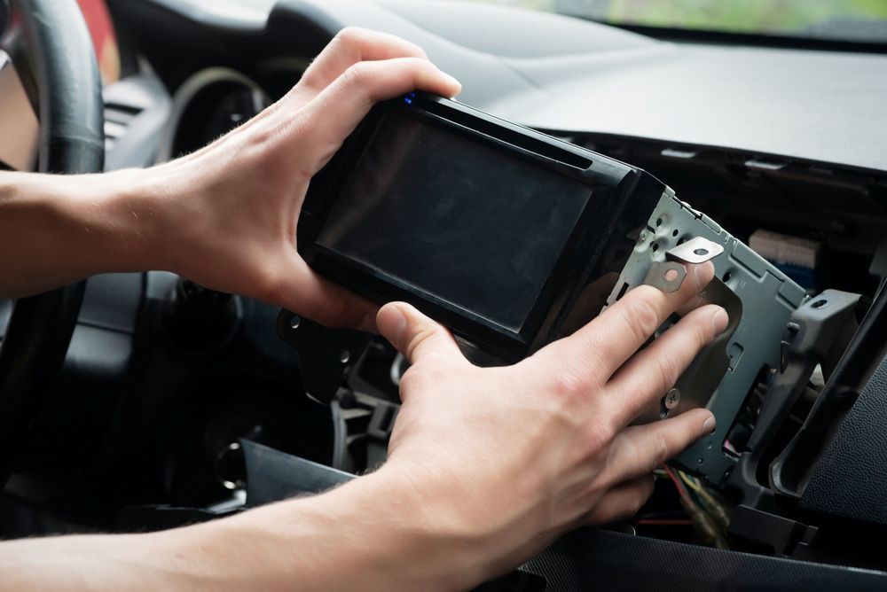 A Person is Installing a Car Radio in a Car — Outlaw Mechanical & Performance In Inverell, NSW