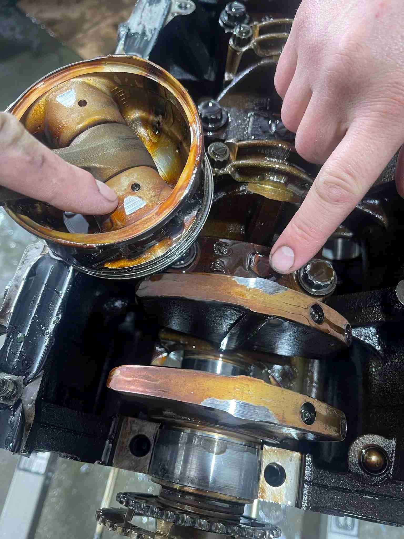 A Person is Working on a Car Engine With Their Fingers — Outlaw Mechanical & Performance In Inverell, NSW
