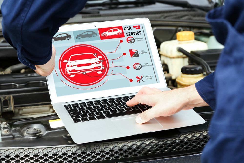 A Person is Using a Laptop Computer Under the Hood of a Car — Outlaw Mechanical & Performance In Inverell, NSW