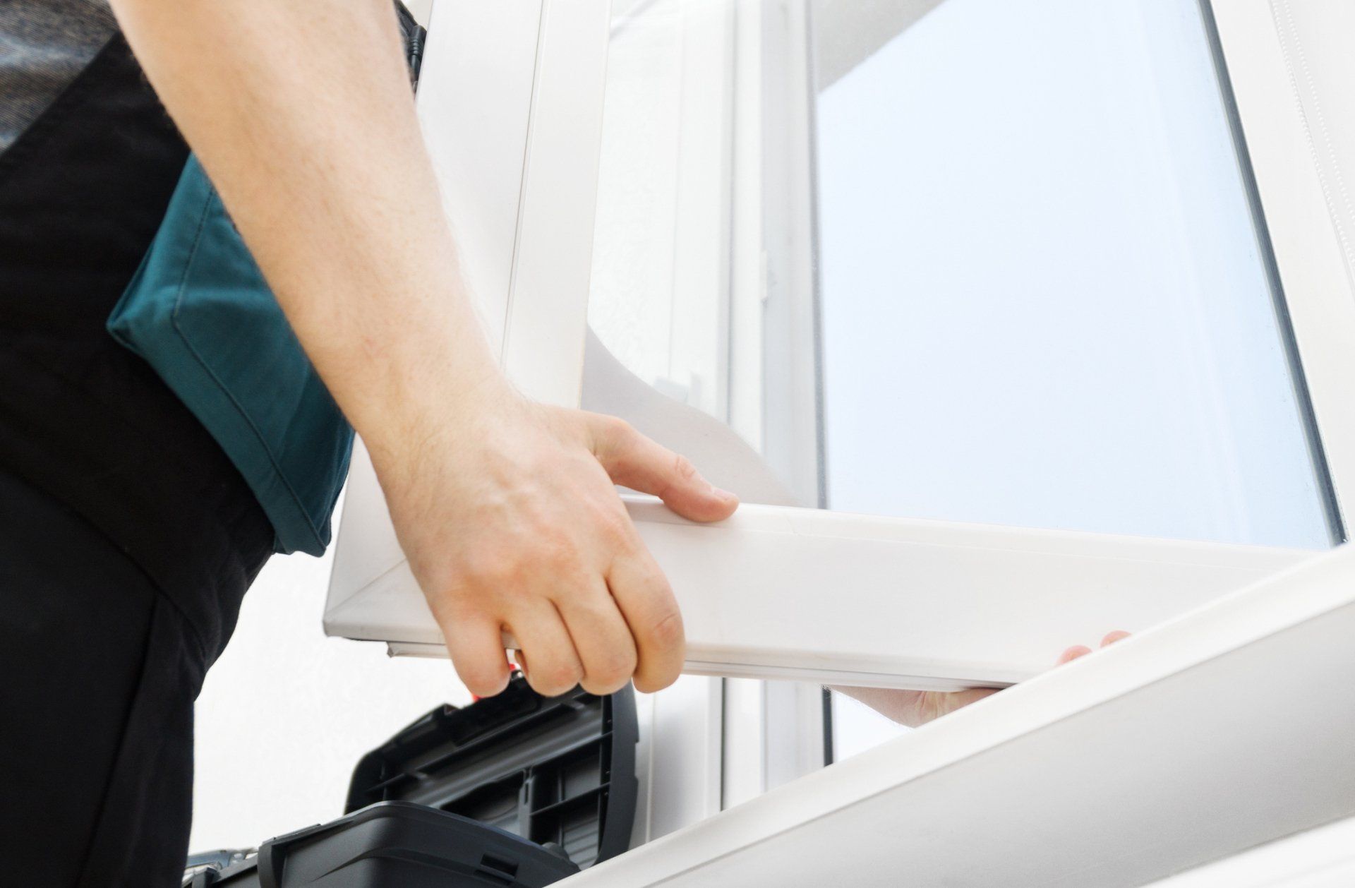 A Window Is Being Installed On A House By A Worker - Capricorn Coast, QLD - Capcoast Glass