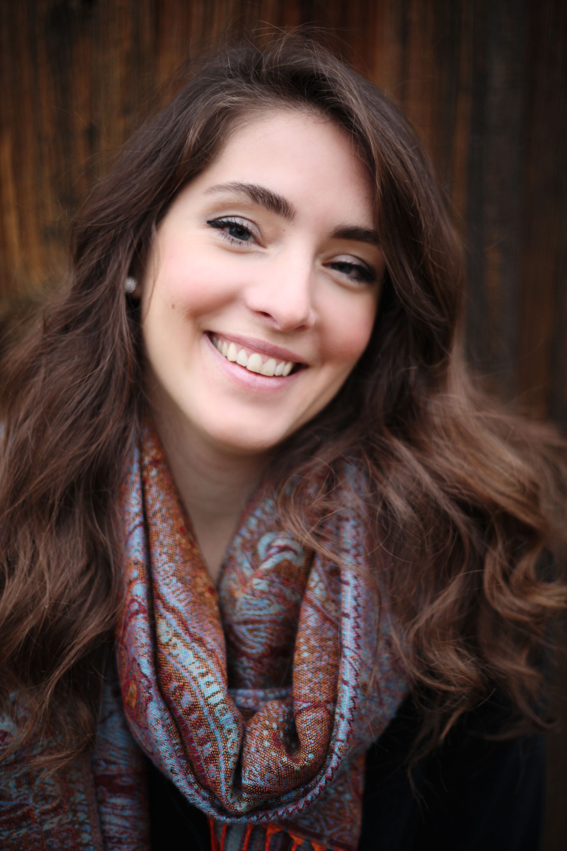 A young girl is singing into a microphone.