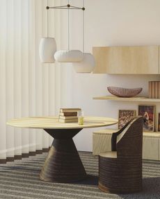 Dining room: round wooden table, chair, pendant lights, shelves with decor against a white wall.