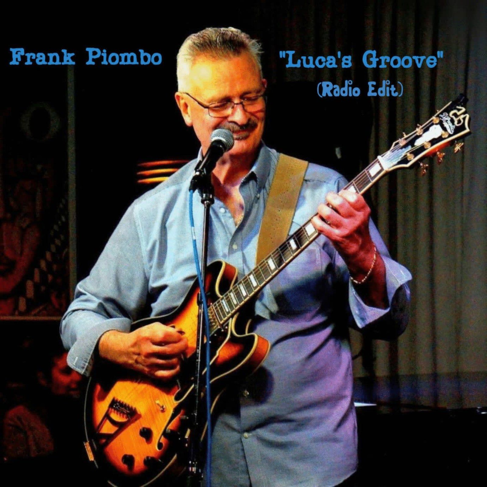 Frank Piombo, playing guitar and singing on stage.