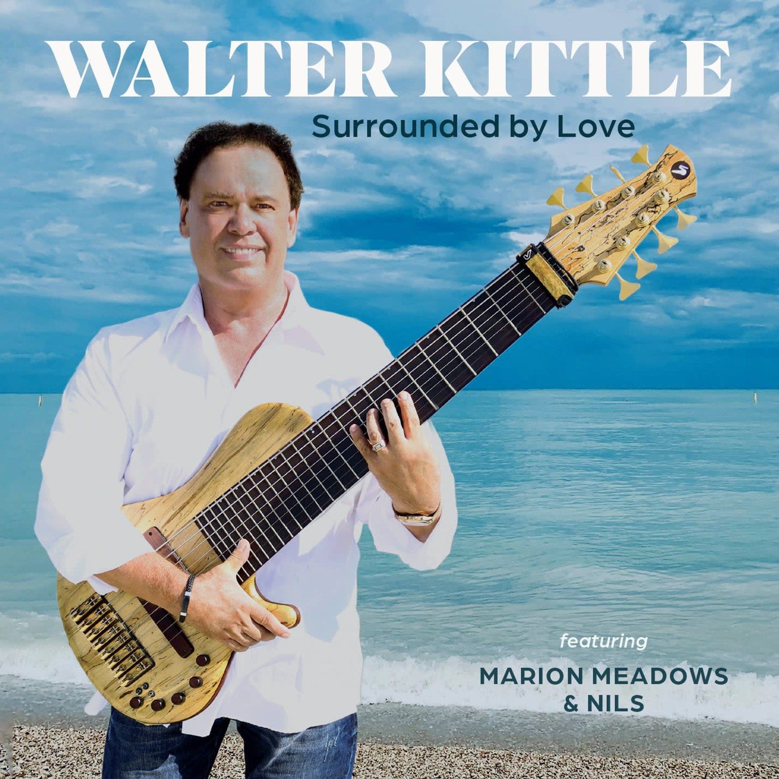 Walter Kittle holding a long-necked bass guitar on a beach. Album cover 