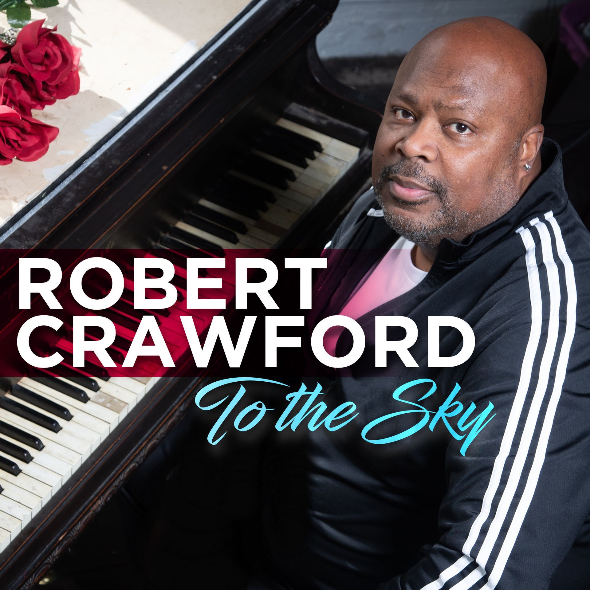 Robert Crawford, seated at a piano, with a black jacket and the album title 