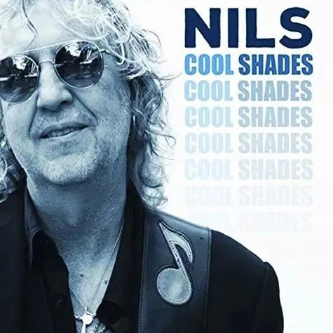 Nils album cover. Smiling man with sunglasses, wearing a black shirt, and a guitar strap. Title 