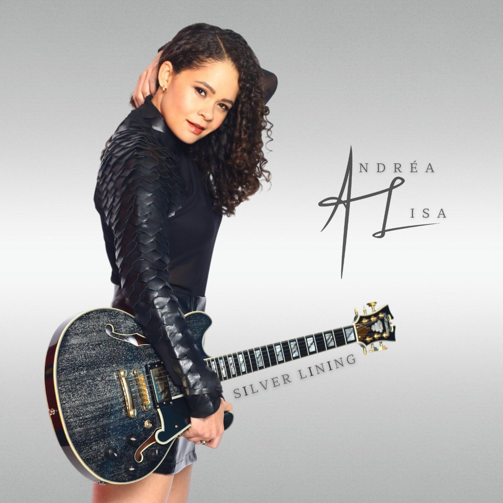 Andrea Lisa holding a silver guitar, wearing a black leather jacket. Album cover with signature and text 