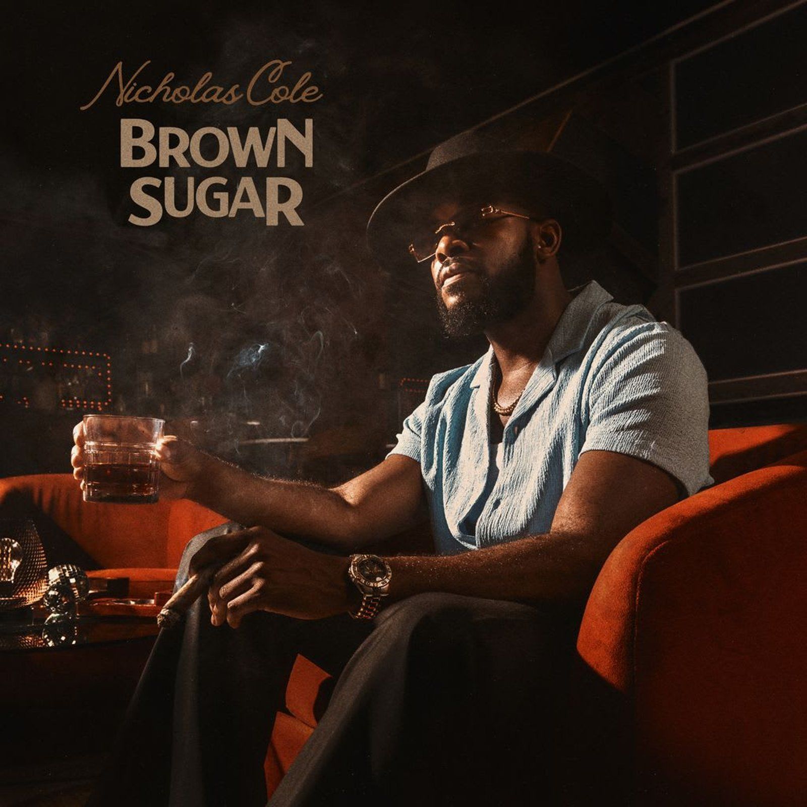 Nicholas Cole on couch, holding glass, smoking; album cover for 