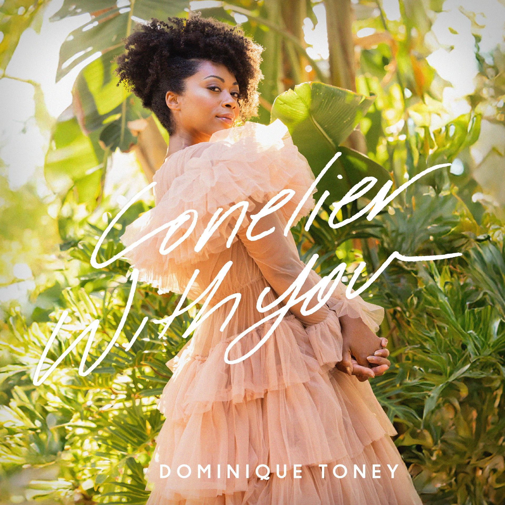 Dominique Toney in a peach dress, standing in a lush garden. The album title 