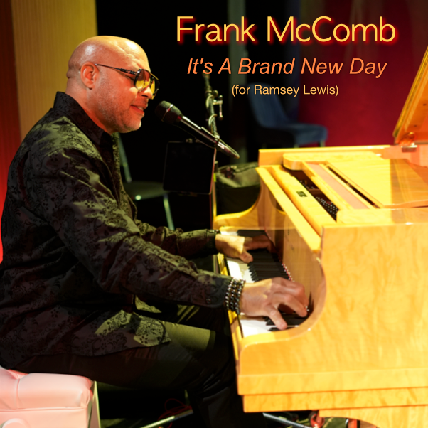 Frank McComb at piano, playing and singing. Orange lighting. Album cover 