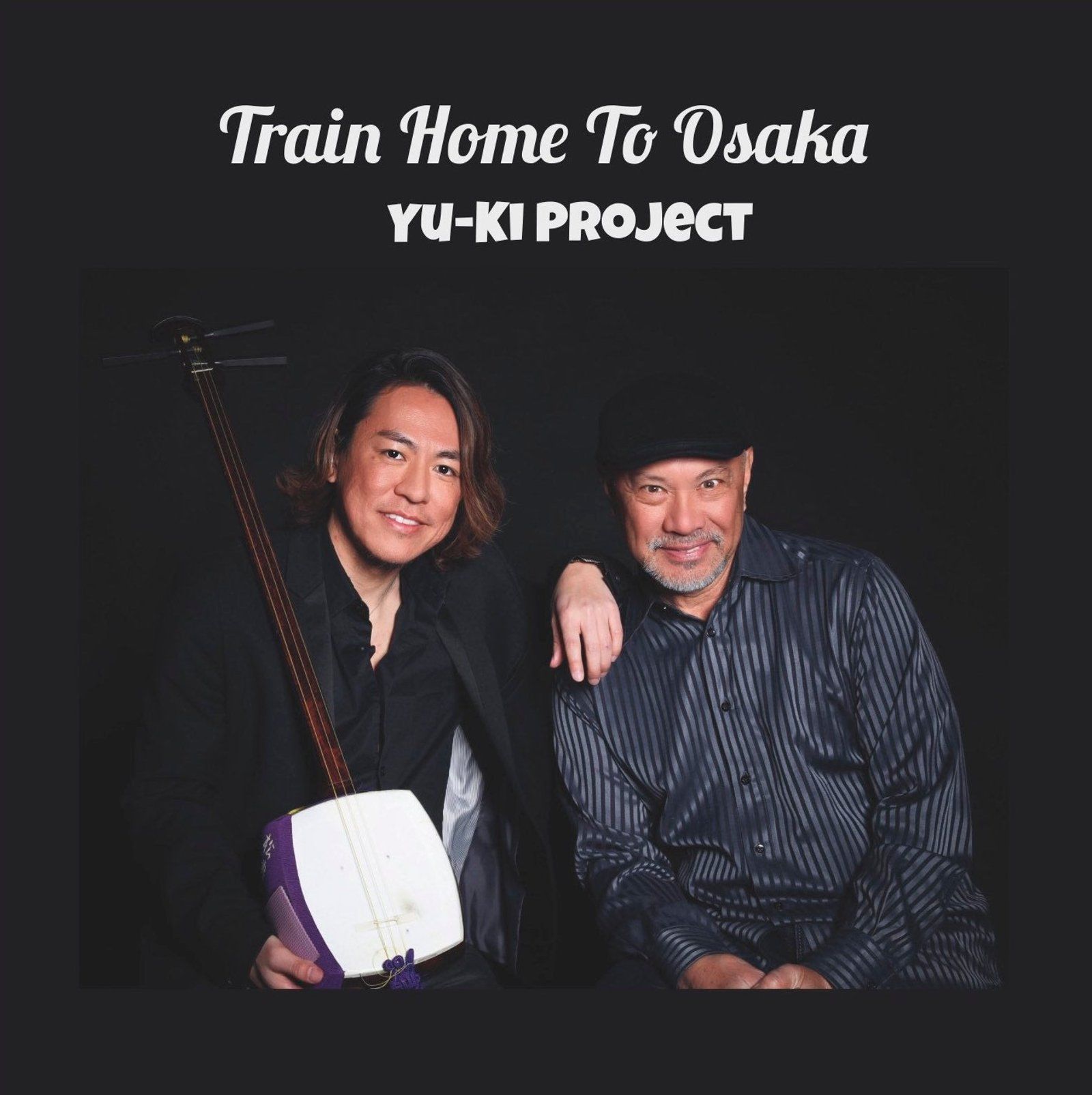 Two men posing. One holds a shamisen. Album cover for 