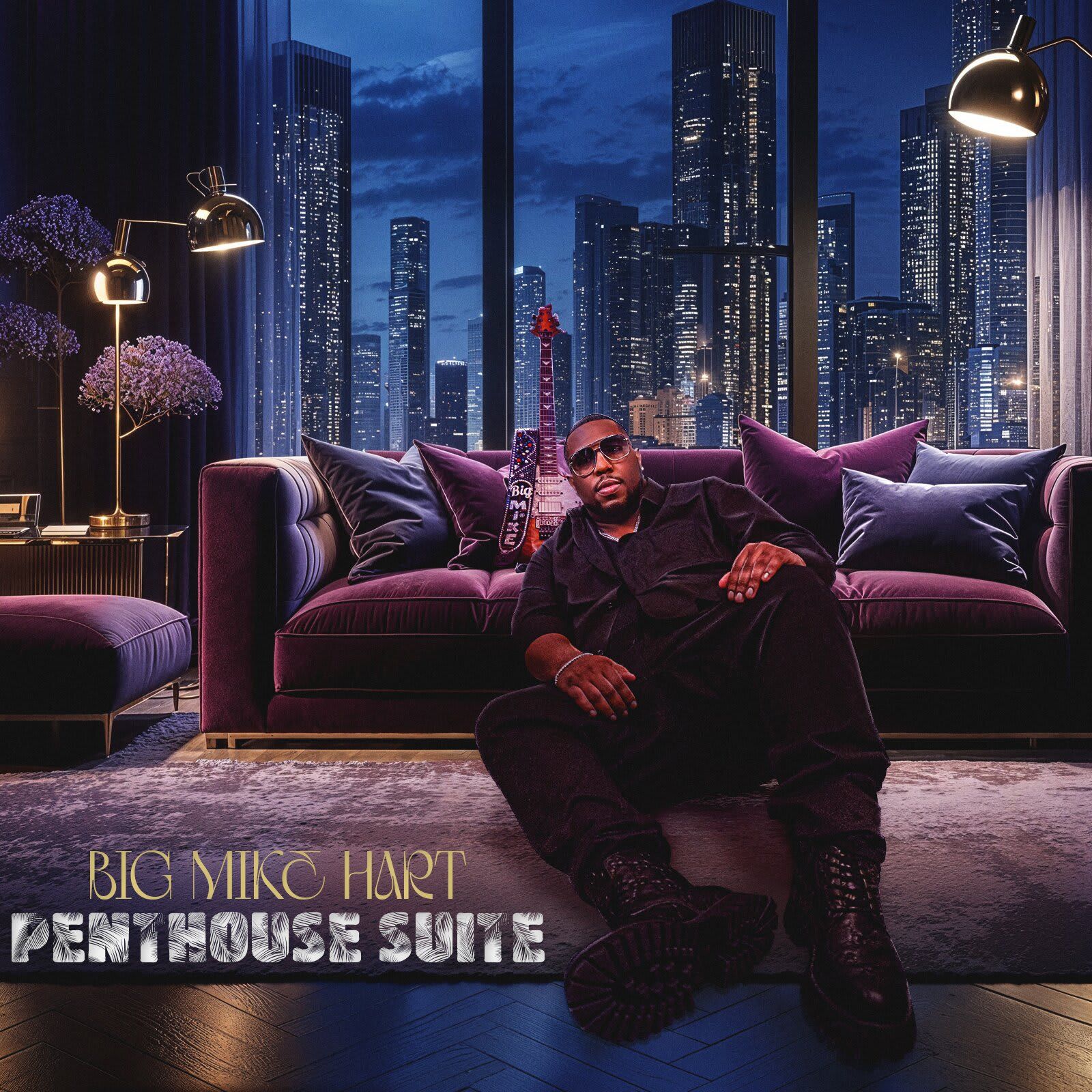Big Mike Hart sits in a purple penthouse, a guitar beside him, city skyline in the background.