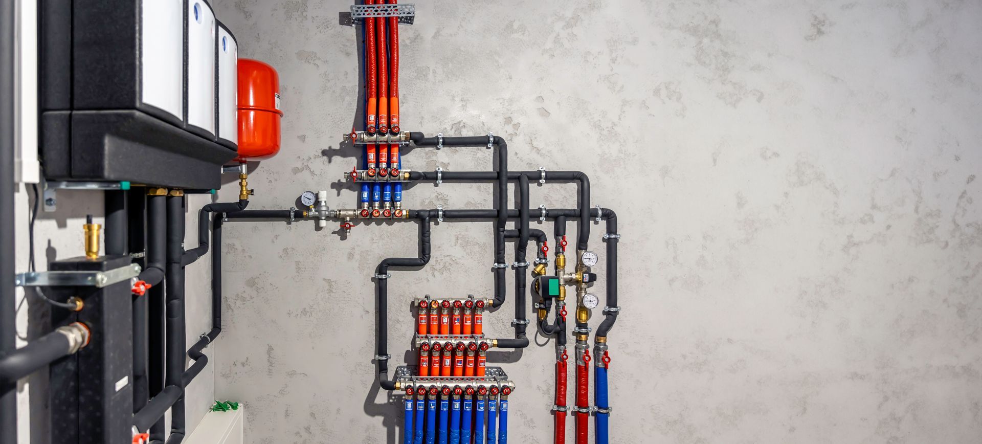 A bunch of gas pipes are hanging on a wall in a room.
