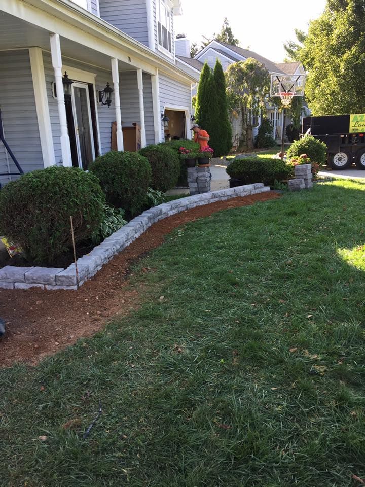 A house with a lush green lawn in front of it.
