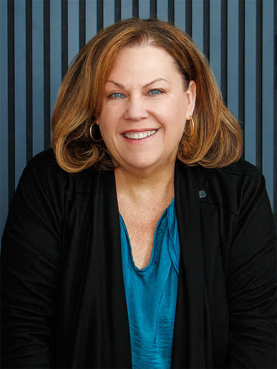 ALICIA MESSA HEAD SHOT WITH BLUE BACKGROUND