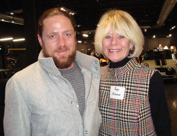A man and a woman are posing for a picture and the man has a name tag that says jim