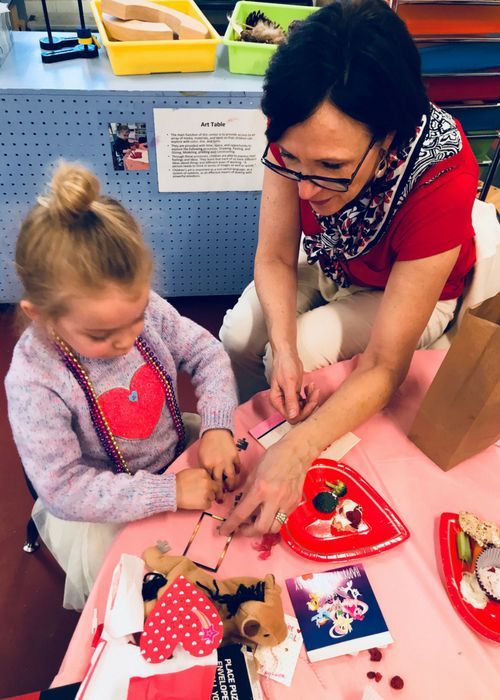 A woman and a little girl are sitting at a table