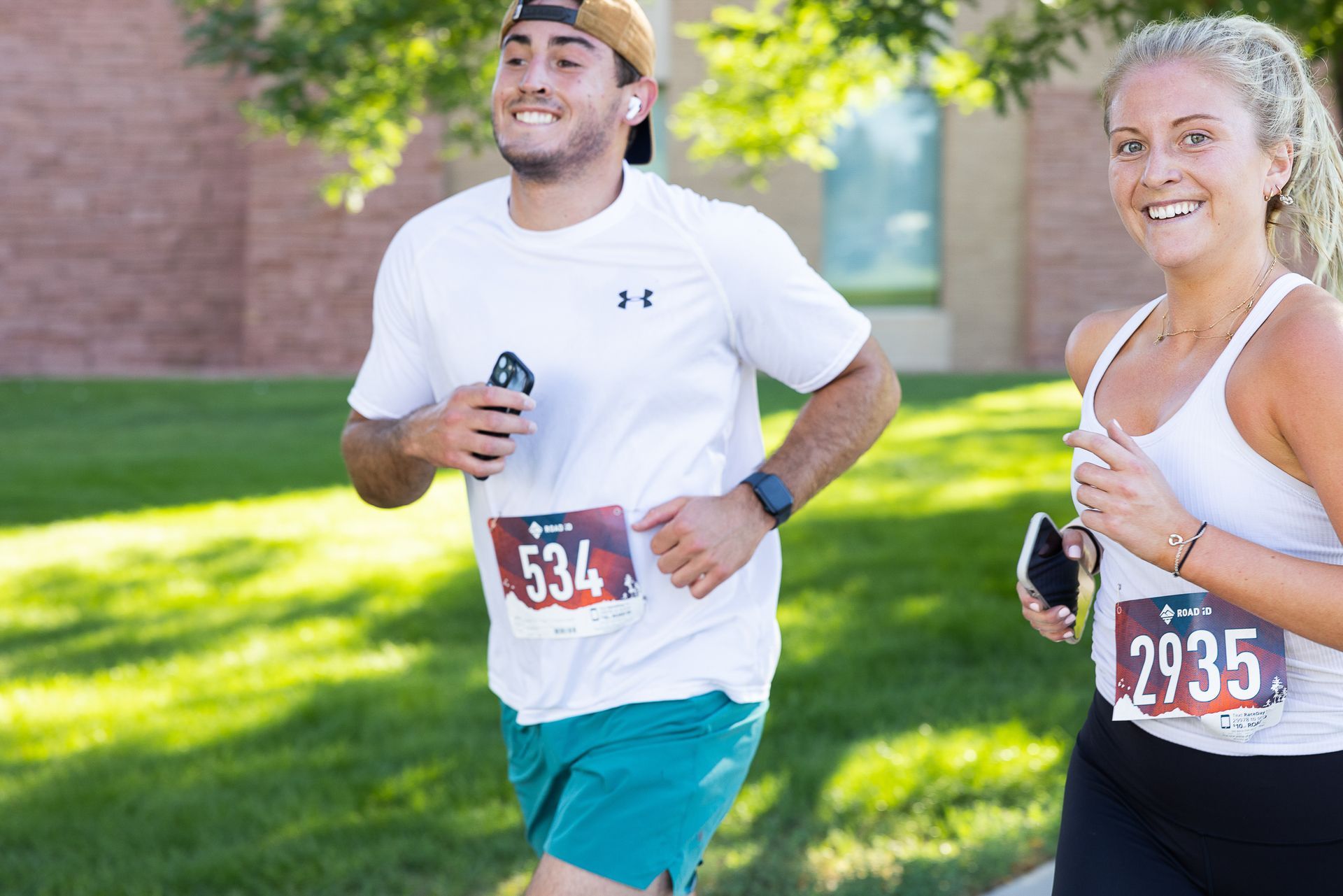 Young man in white t-shirt and blue shorts running in CDF's Run for the Ring 5K.