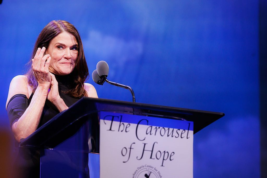 CDF Executive Director Dana Davis on stage giving a speech at Carousel of Hope.