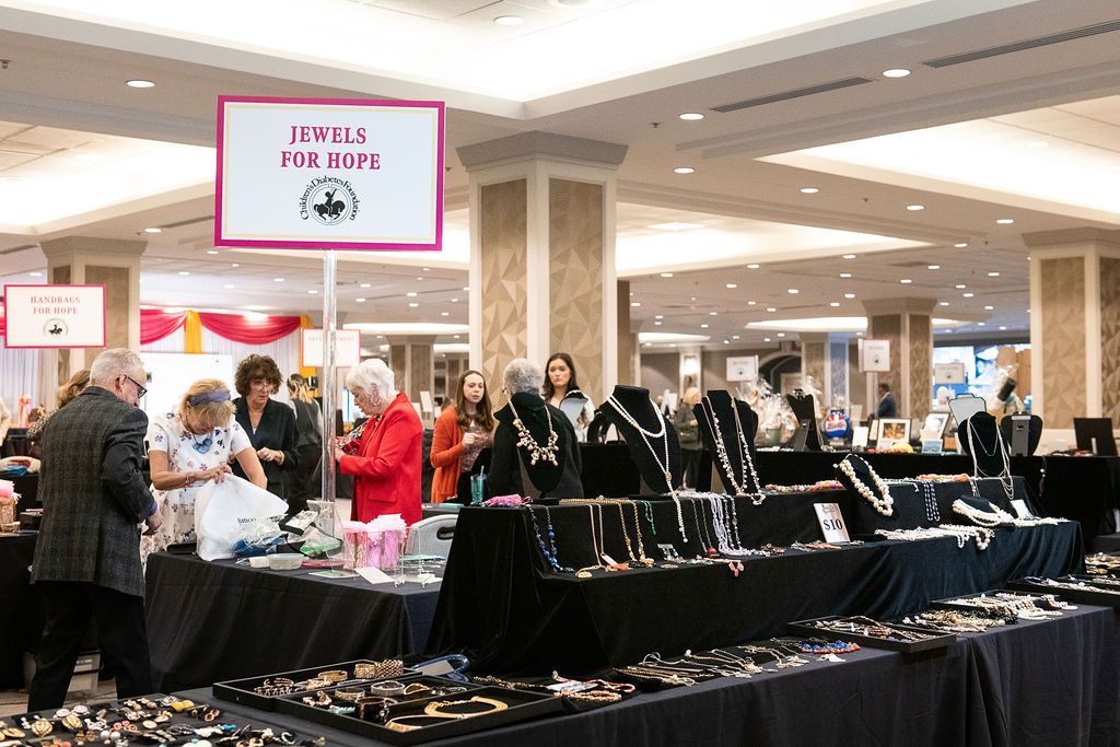 Brass Ring Luncheon attendees shopping at the large Jewels for Hope booth during the silent auction.