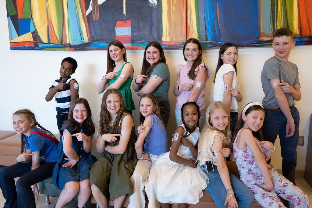 Children at the Barbara Davis Center for Diabetes showing off their devices and pumps. 
