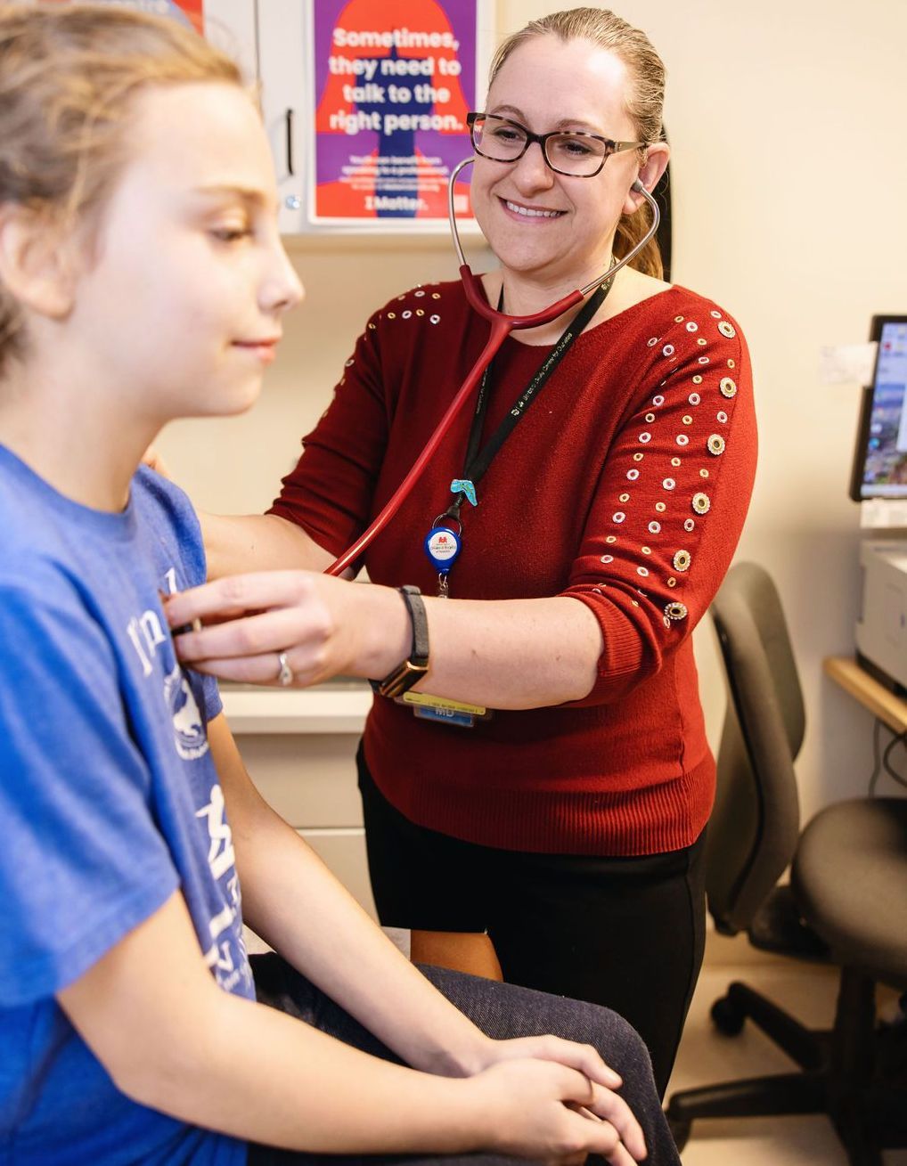 Female nurse listening to the heartbeat of a young patient at the BDC.
