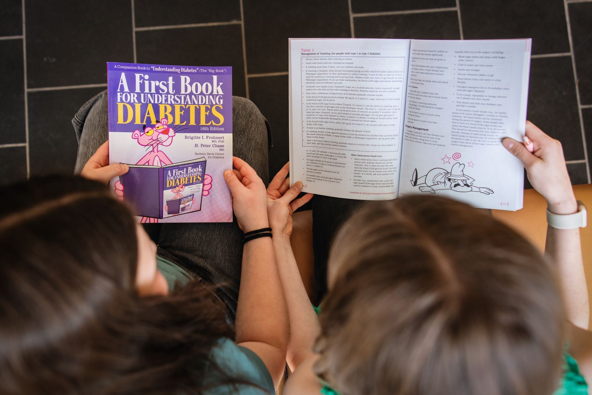 Arial view of two people reading Pink Panther books about type 1 diabetes.