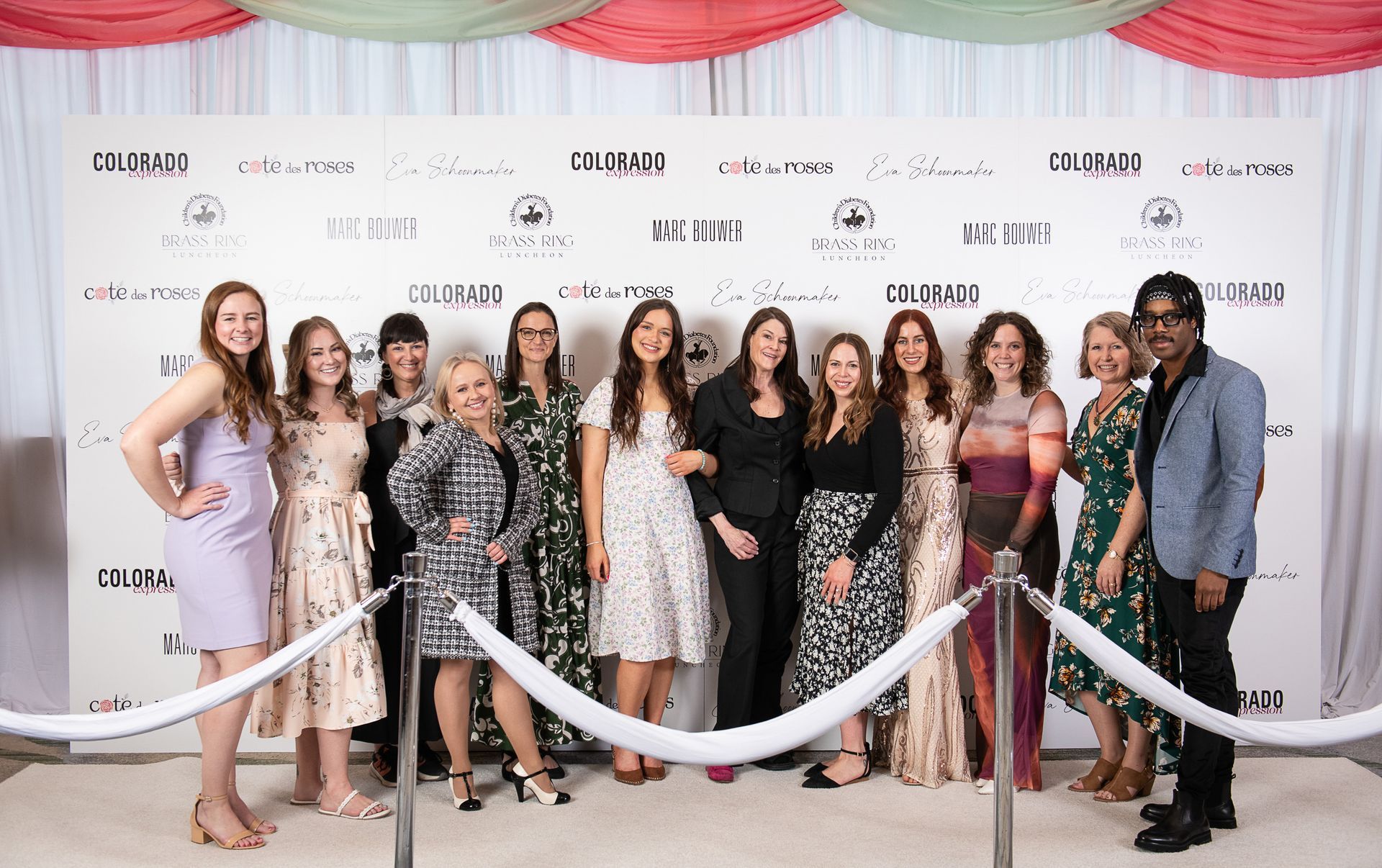 CDF Staff smiling and standing together on the step and repeat carpet at Brass Ring Luncheon.