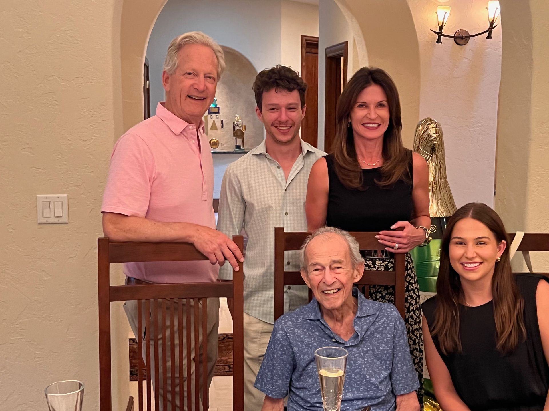 A group of people are posing for a picture in a living room.