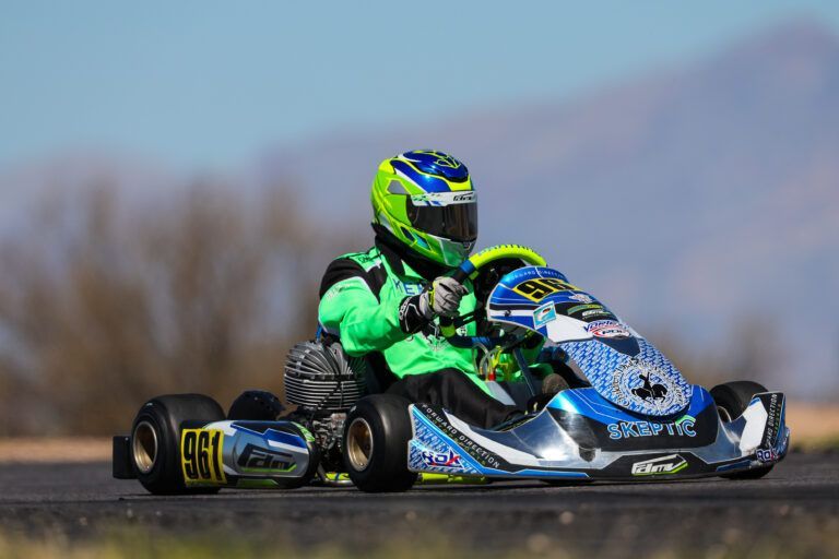 A person is riding a go kart on a track.