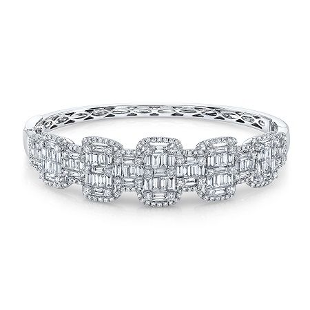 The bracelet is made of white gold and has a lot of diamonds on it.