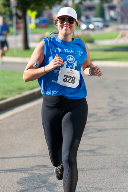 A woman wearing a blue shirt with the number 328 on it