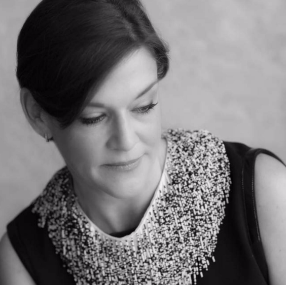 A black and white photo of a woman wearing a necklace