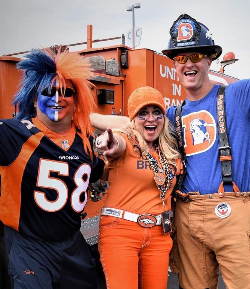 A group of broncos fans are posing for a picture