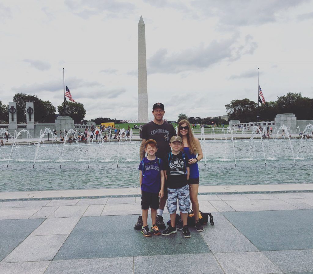 A family posing for a picture in front of a fountain