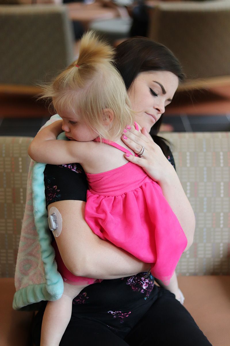A woman is holding a little girl in her arms.