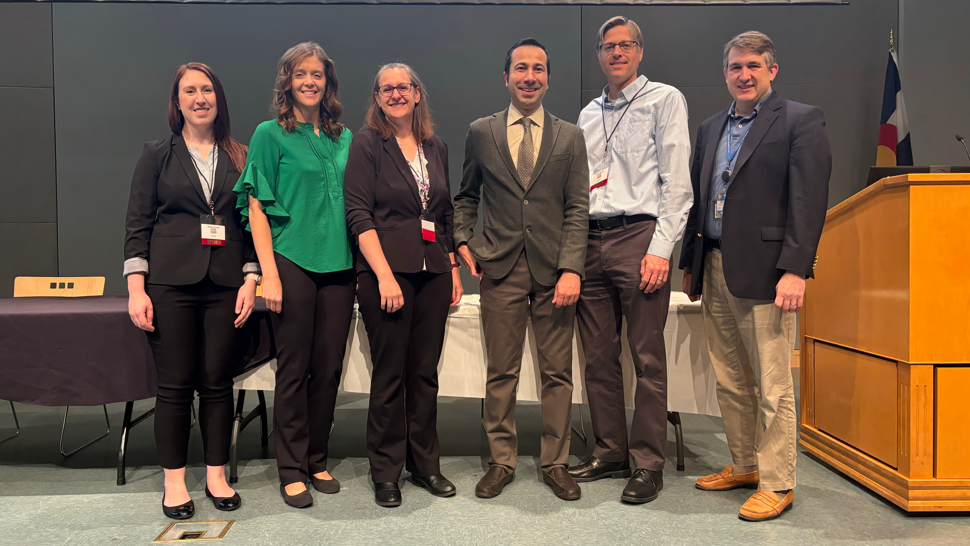 Panel of six experts standing on stage to present at EPIC Diabetes Conference. 