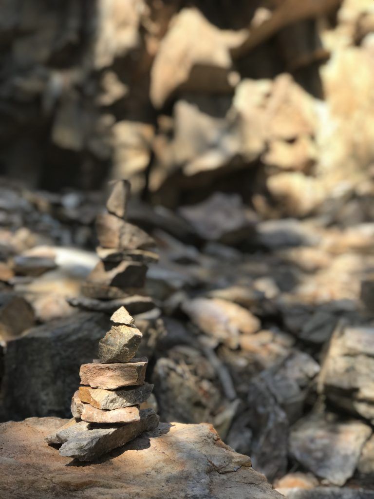 A pile of rocks stacked on top of each other on a rocky surface.