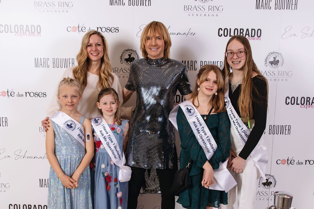 Designer Marc Bower poses with type 1 diabetes advocates at the 2025 Brass Ring Luncheon and Fashion Show.