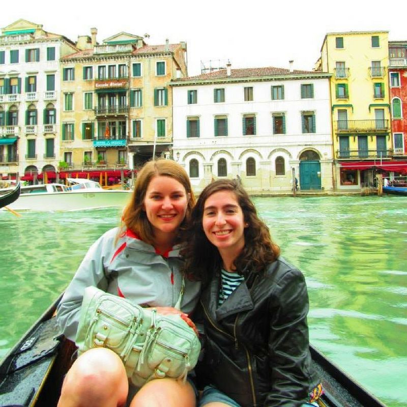 Two women are posing for a picture in a boat