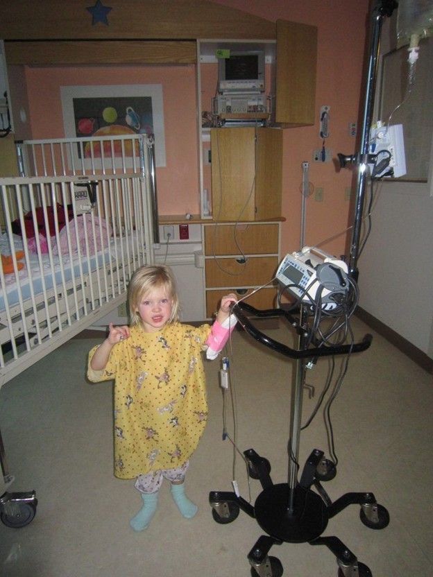 Young girl with T1D in hospital gown and room
