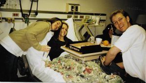 A group of people are posing for a picture in a hospital room.