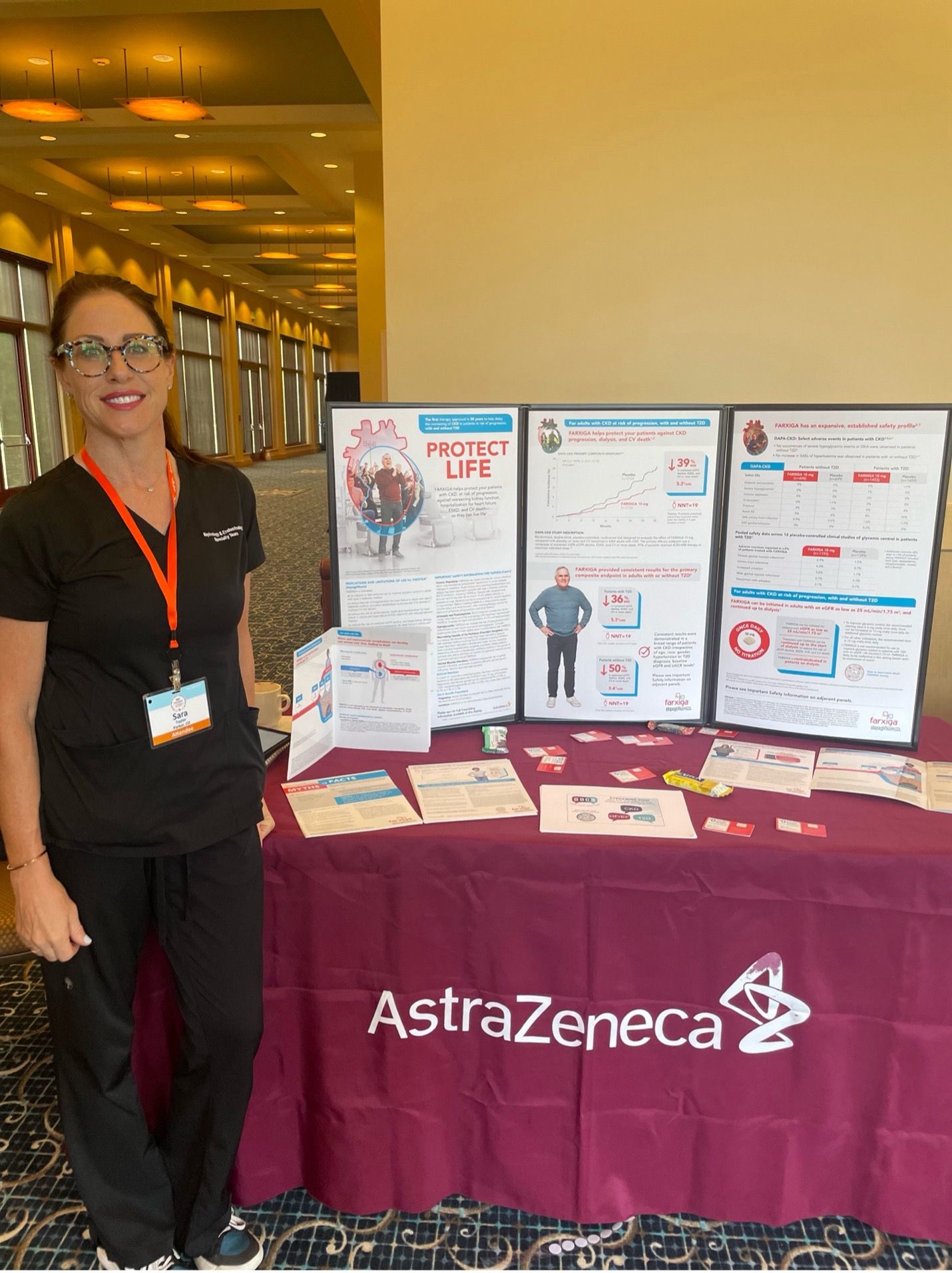 AstraZeneca exhibitor and her booth of information at the conference.