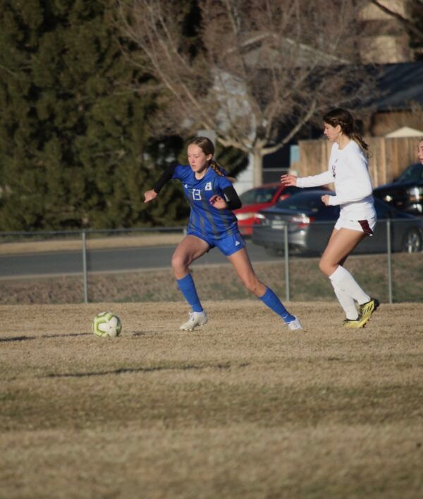 A girl in a blue jersey with the number 8 on it