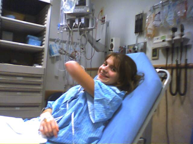 A woman in a hospital gown is laying in a hospital bed