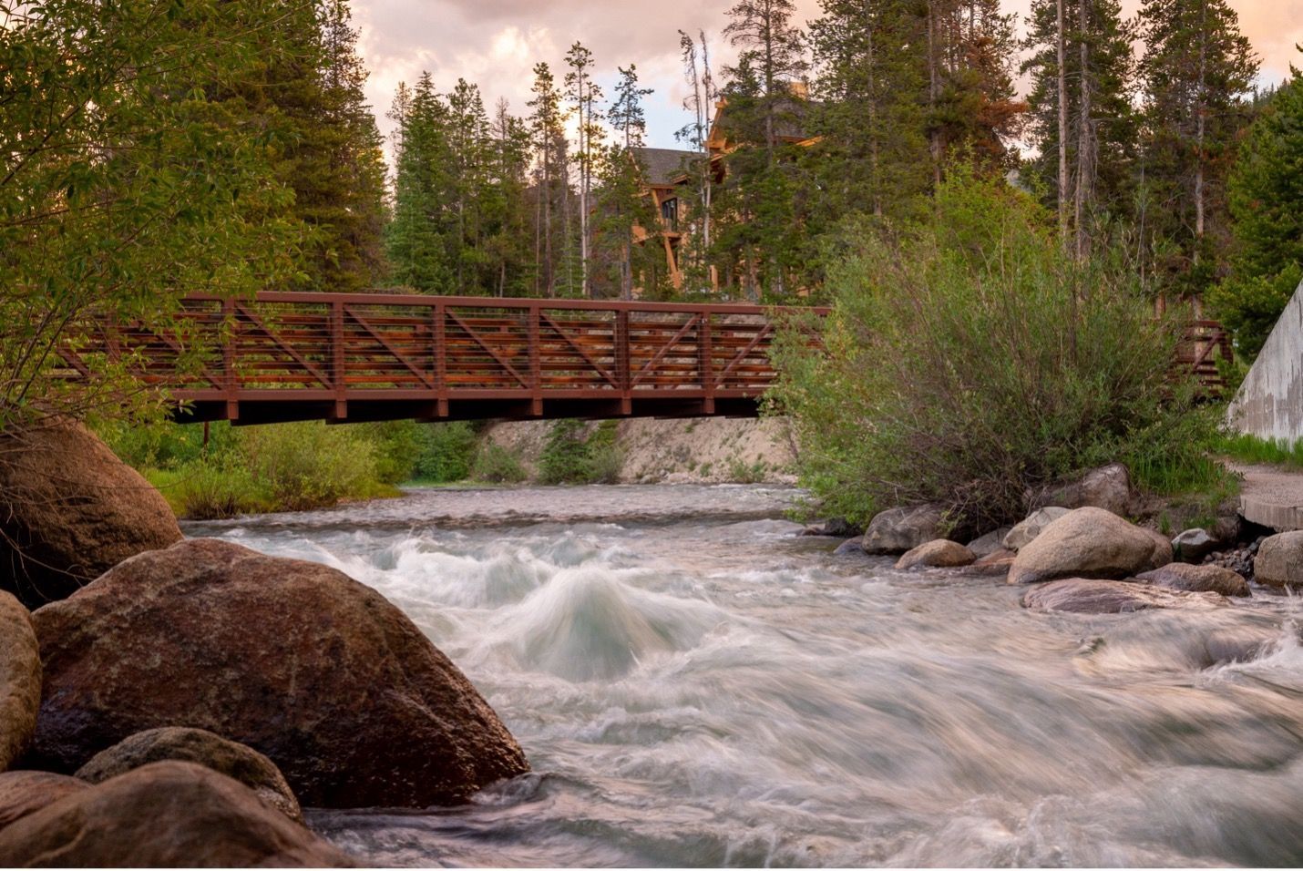 Cloudy night with moon shining through in the mountains.