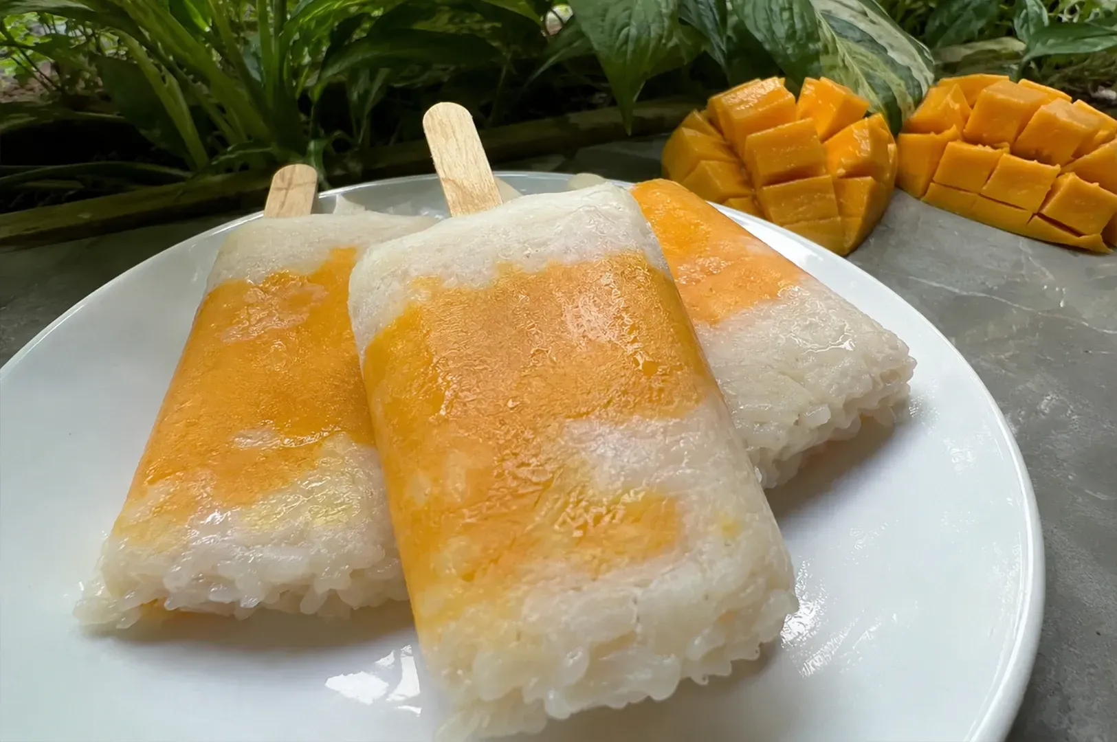 Two pineapple drinks with mint on a light stone table in a café
