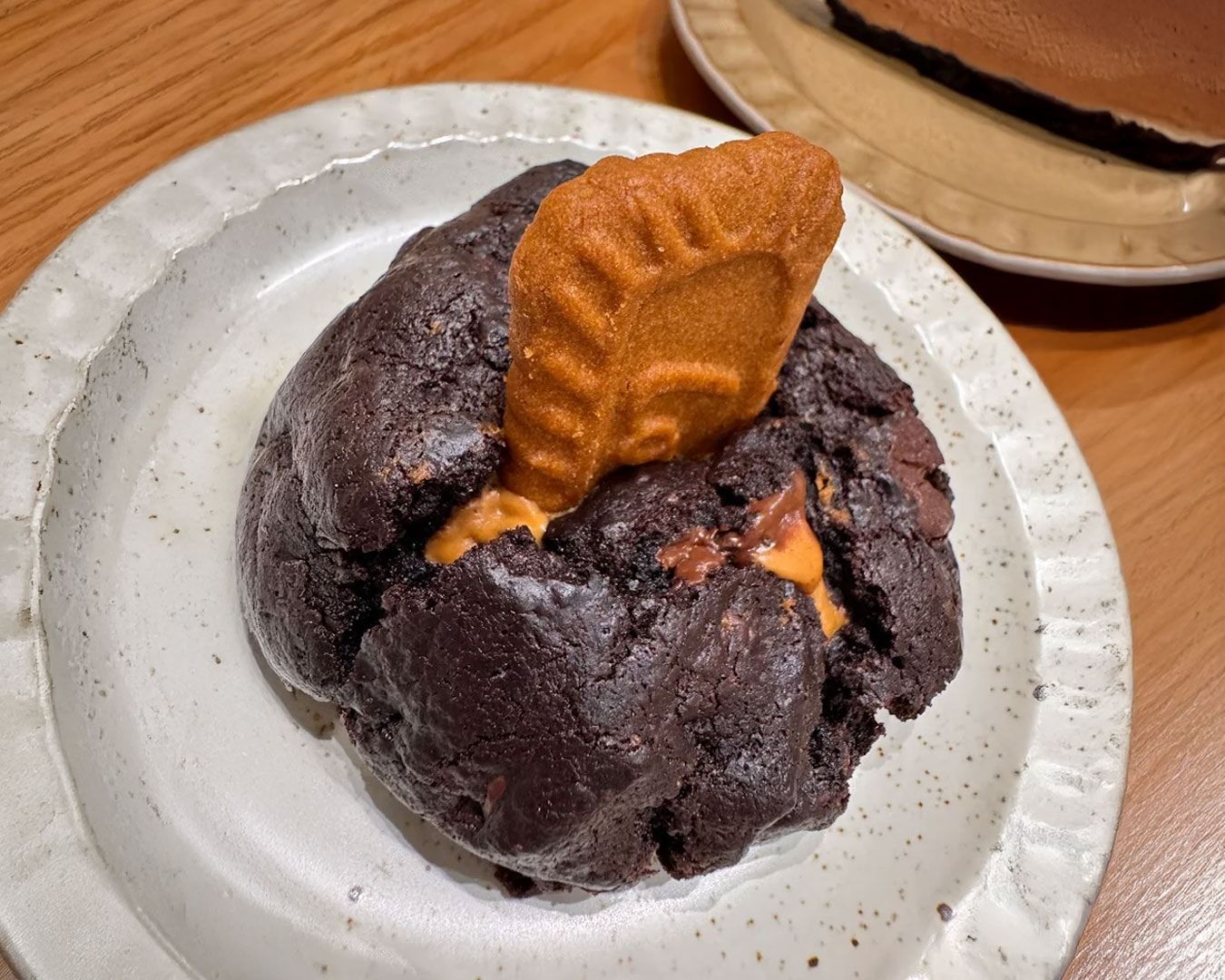 A scoop of soft cookie dough studded with chocolate chips, served as a playful and indulgent dessert.